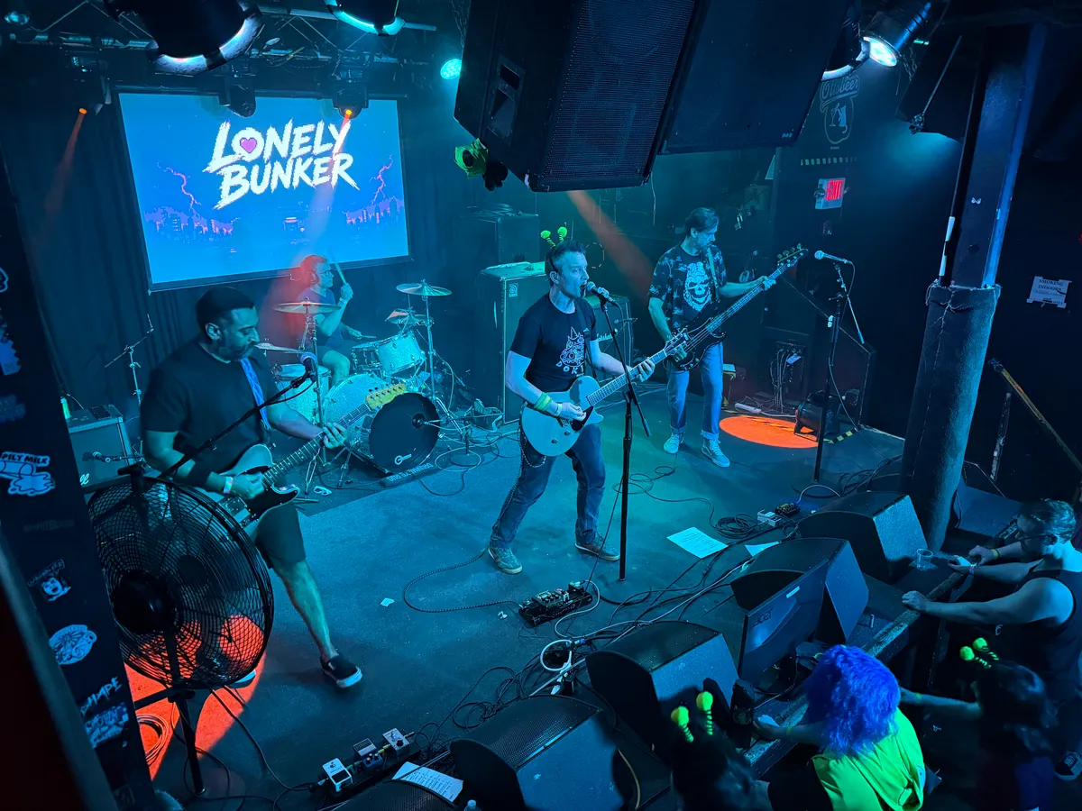 Lonely Bunker on stage at the Ottobar, Baltimore, keyart projected behind the drum kit